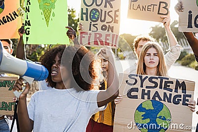 Young group of demonstrators on road from different culture and race protest for climate change - Focus on right girl face Stock Photo