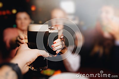Young group of friends drinking beer, having fun, laughting and celebrating together. Stock Photo
