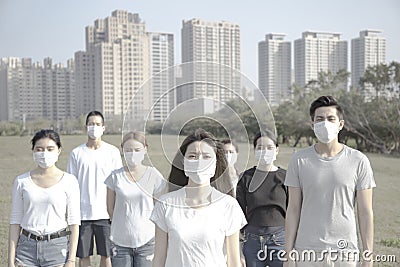 Young group wearing mouth mask against air pollution in city Stock Photo