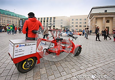 Young guide wait tourists for sightseeing trip by multipassenger circular bike Editorial Stock Photo