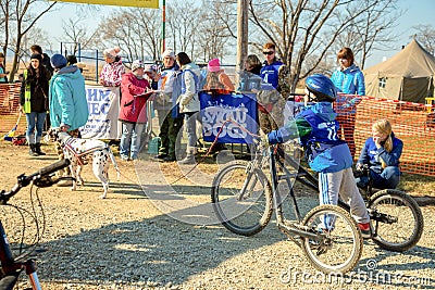 The young guy costs on three the wheel bicycle Editorial Stock Photo