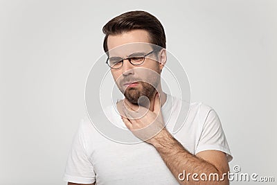 Young guy coughing having sore throat studio shot Stock Photo