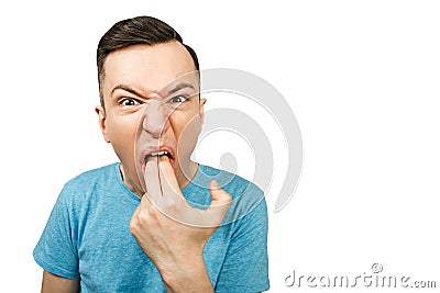 Young guy inserts two fingers in the mouth to induce vomiting, on a isolated white background Stock Photo