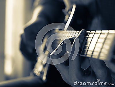 A young guy playing blues on an electric guitar. close-up. Stock Photo