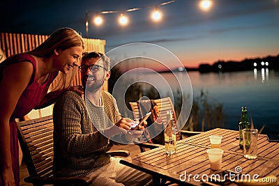 Young guy showing content on his cell phone to a female friend Stock Photo