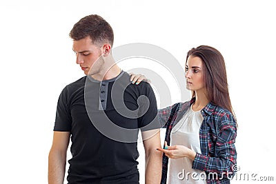 Young guy turned sideways and his girlfriend put her hand on his shoulder Stock Photo