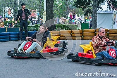 Young guys having fun in the park. Men karting close up. Editorial Stock Photo