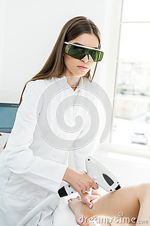 Young hair removal therapist Stock Photo