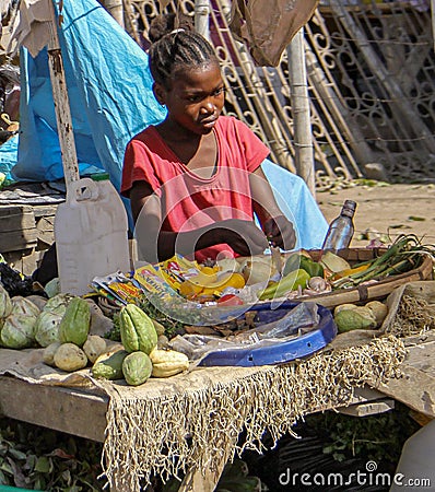 Young Haitian girl helps out at a roadside stand near Cap Haitian. Editorial Stock Photo