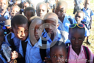 Young Haitian school girls and boys in curiously pose for camera in rural village. Editorial Stock Photo