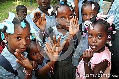 Young Haitian school children show friendship bracelets in village. Editorial Stock Photo