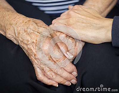 Young hand consoling old hands Stock Photo