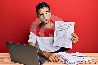 Young handsome african american man showing failed exam thinking attitude and sober expression looking self confident Stock Photo