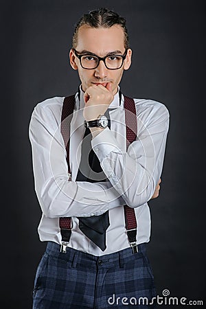 Young handsome boy in white shirt with tie and glases, clock on hand Stock Photo