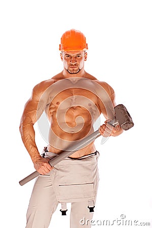 Young and handsome builder with a sledgehammer and Stock Photo