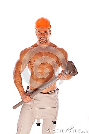 Young and handsome builder with a sledgehammer and Stock Photo