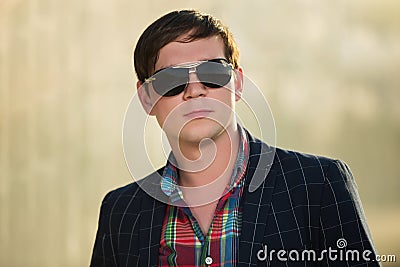 Young handsome business man in black blazer and sunglasses Stock Photo