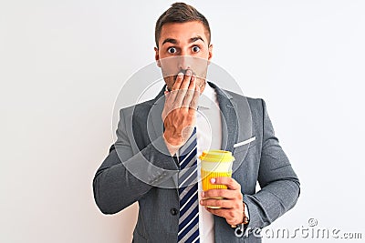 Young handsome business man drinking take away coffee over isolated background cover mouth with hand shocked with shame for Stock Photo