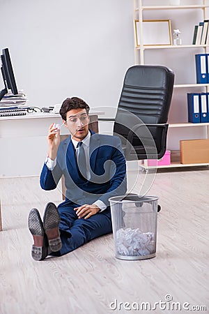 Young handsome businessman employee working in office in paperwo Stock Photo
