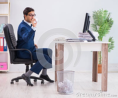 Young handsome businessman employee working in office in paperwo Stock Photo