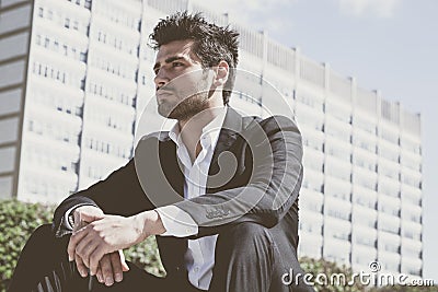 Young and handsome businessman sitting thinking Stock Photo