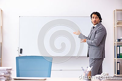 The young handsome businessman standing in front of whiteboard Stock Photo