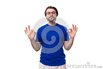 young handsome caucasian man with dark well-groomed hair and beard dressed in a blue t-shirt Stock Photo