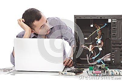 young handsome computer specialist look confuse repairing computer Stock Photo