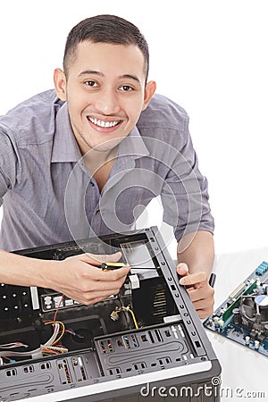 young handsome computer specialist repairing computer Stock Photo