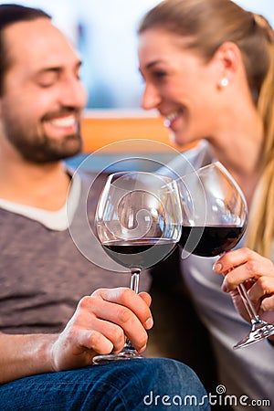 Young handsome couple drinking red wine Stock Photo