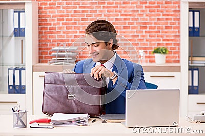 The young handsome employee working in the office Stock Photo