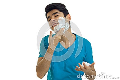 Young handsome guy with black hair tilted head and deals on face shaving foam Stock Photo