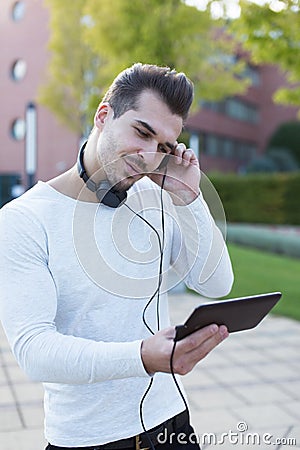 Man listening music by headphones in park enjoying rythm Stock Photo