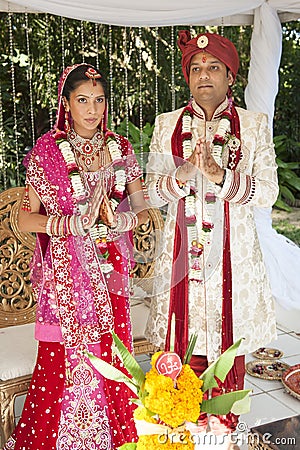 Young handsome Hindu bridal couple in traditional attire with wedding ceremony make up Stock Photo