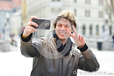 Young handsome hipster man making funny selfie Stock Photo