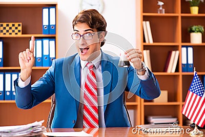 The young handsome politician sitting in office Stock Photo