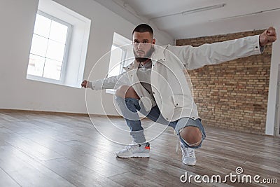 Young handsome male dancer in fashion clothes with ripped jeans Stock Photo