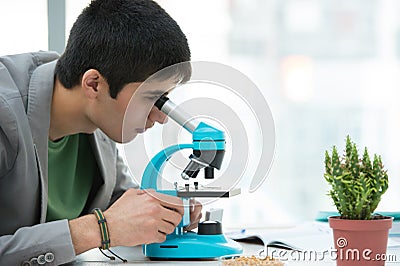 Young handsome male student using microscope Stock Photo