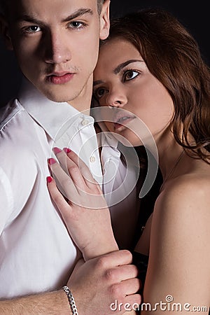 Young handsome man in a business suit and a white shirt in official style with beautiful girl, couple in love in the Studio Stock Photo
