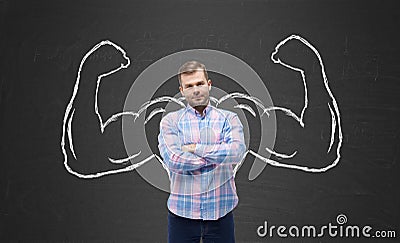 Young handsome man in casual shirt with drawn powerful hands. Stock Photo