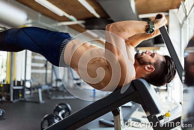 Young handsome man doing exercise for abdominal muscles Stock Photo