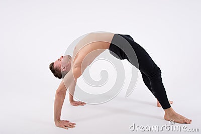 Young handsome man and exercises. Training and relaxation. Stretching and warm-up Stock Photo