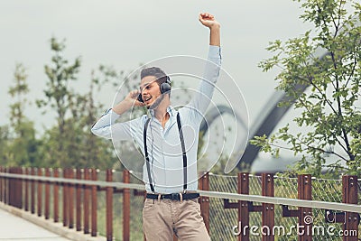 Young handsome man listening to music in an urban context Stock Photo