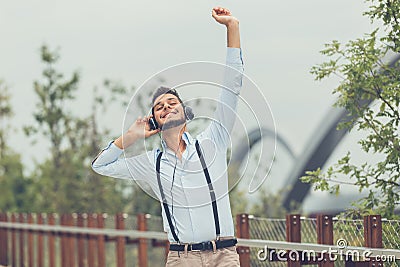 Young handsome man listening to music in an urban context Stock Photo