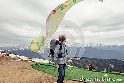 Young handsome man is looking at people who are fond of base jumping Stock Photo