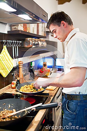 Young handsome man preparing dinner Stock Photo