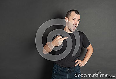 Young handsome man screaming and showing middle finger Stock Photo
