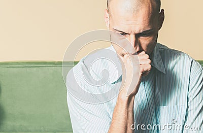 Young handsome man in the shirt with sad face expression feeling depressed and miserable while he thinking about life. Stock Photo