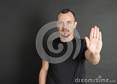 Young handsome man showing stop gesture Stock Photo