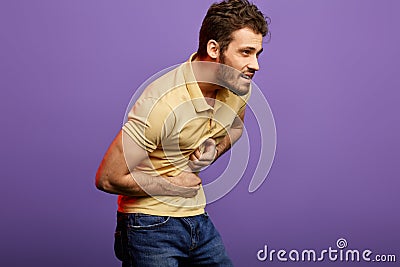 Young handsome man in stylish casual clothes having a heart attack. Stock Photo